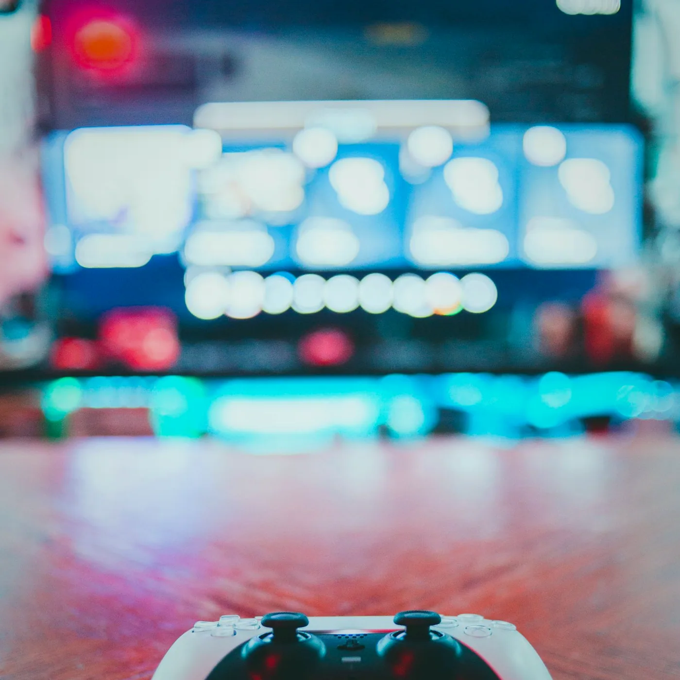 A close view of a keyboard with a pair of headphones draped over it