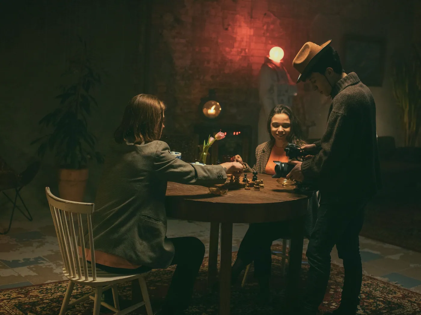 Four adults talking and laughing around a table in the club room